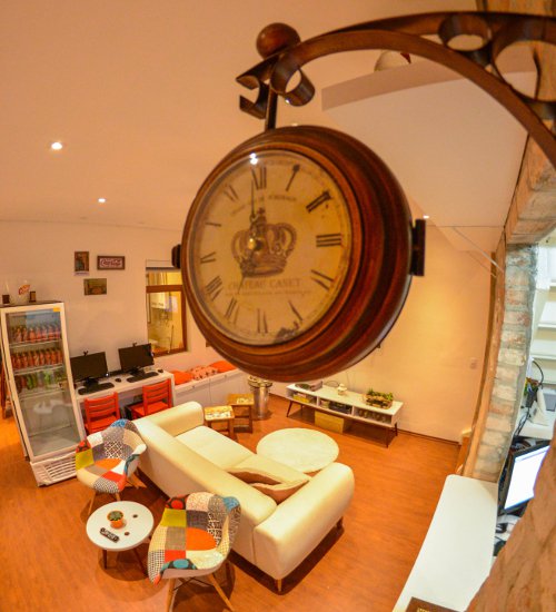 Sala de estar do hotel didshostel com um relógio antigo pendurado